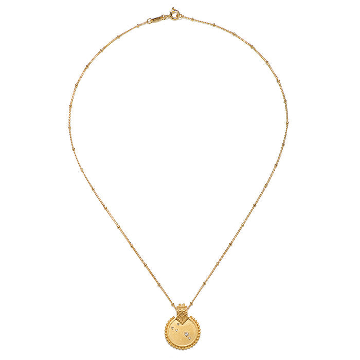 The Mandala Zodiac Aries White Topaz Necklace showcasing its detailed round pendant and chain. This meaningful piece of spiritual jewelry is perfect for yoga enthusiasts and those interested in zodiac symbolism, embodying protection and the essence of individualism and creativity.