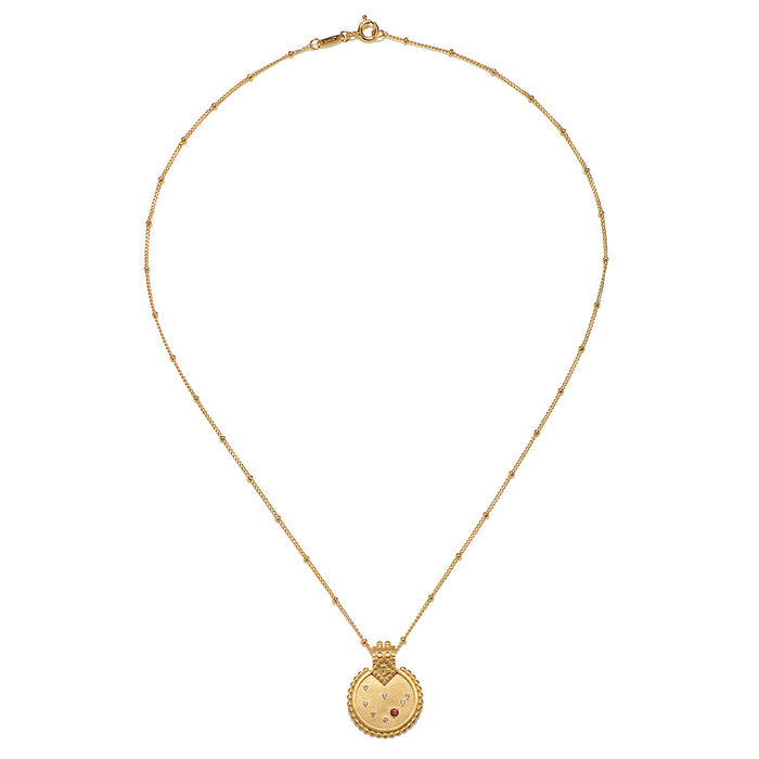 Mandala Zodiac Capricorn Red Garnet Necklace displayed elegantly, crafted with 18kt gold plating, embodying spiritual jewelry and a meaningful amulet for meditation, manifestation, and yoga enthusiasts.