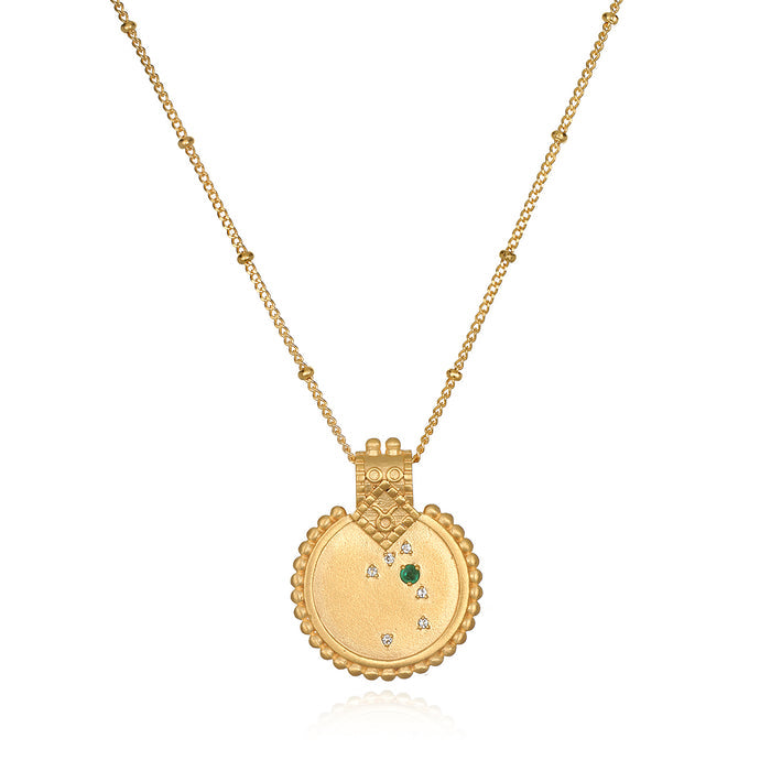 The Mandala Zodiac Taurus Emerald Necklace displayed elegantly, featuring the emerald stone and crafted in 18kt gold plate. This spiritual jewelry captures the essence of Taurus, making it a perfect meditation gift and a meaningful amulet for manifestation with protective and sacred qualities.