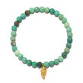 Stretch bracelet with green agate beads and gold-tone conch shell charm pendant.