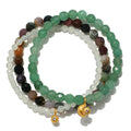 Manifest Peace Gemstone Bracelet Set featuring vibrant green aventurine, fancy jasper, and new jade beads, designed for spiritual jewelry enthusiasts seeking tranquility, protection, and meaningful meditation experiences. Adorned with sun and moon charms, this talisman promotes manifestation and is perfect for yoga practitioners.