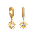 Gold-plated huggie hoops with textured bands and dangling sun charms set with white topaz stones.