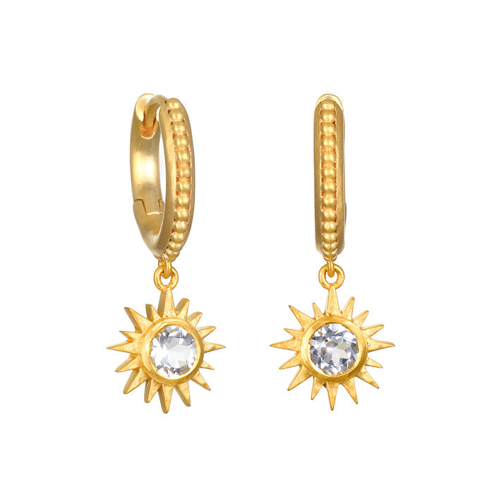 Gold-plated huggie hoops with textured bands and dangling sun charms set with white topaz stones.