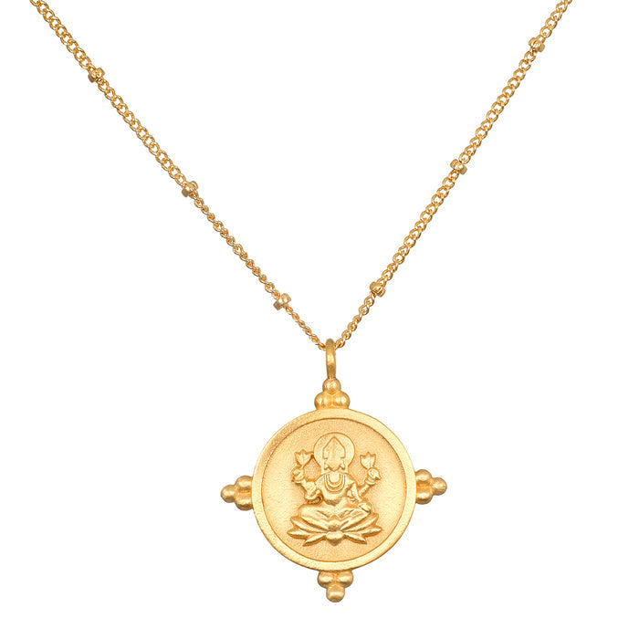 Gold-toned chain necklace with circular coin pendant featuring deity figure and decorative elements.
