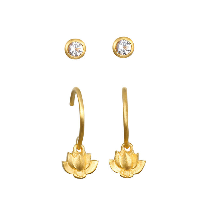 Pair of gold-toned earrings with white topaz studs and lotus flower drop charms on curved hooks.