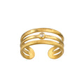 Gold-toned adjustable cuff ring with white topaz stone and textured bands.