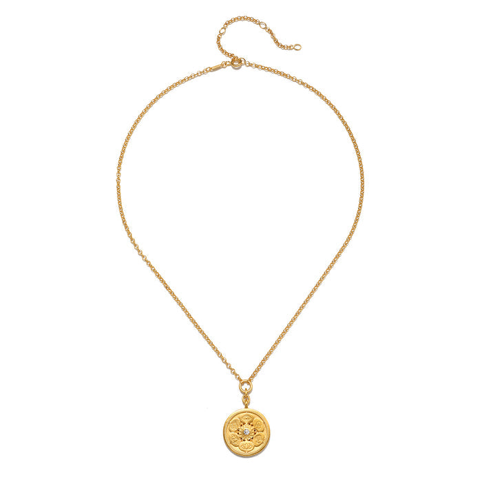 Gold-tone chain necklace with circular coin pendant featuring etched design.