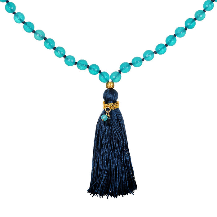 Many Truths Angelite and Blue Topaz Gemstone Mala featuring vibrant turquoise beads and a decorative dark navy tassel. This spiritual jewelry is ideal for meditation gifts, symbolizing meaning, protection, and manifestation.