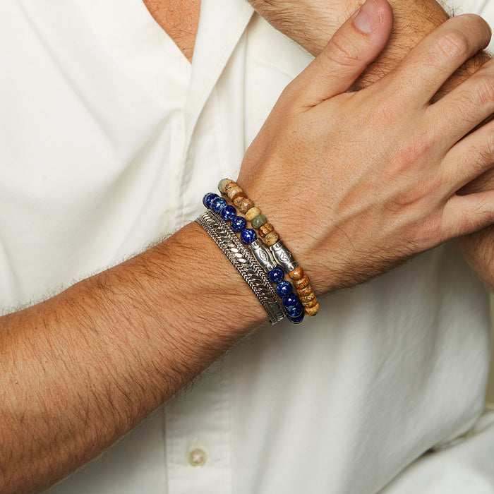 Men's Eye Lapis Gemstone Bracelet displayed on a wrist, showcasing its vibrant blue hue and the etched eye of protection bead. This piece of spiritual jewelry symbolizes wisdom, protection, and meaningful manifestation, perfect for meditation and yoga.