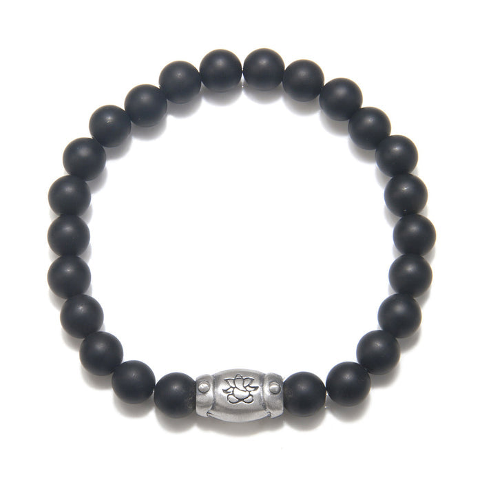 Men's Ganesha Hindu God Black Onyx Bracelet featuring matte black onyx beads and a sterling silver barrel bead accent, perfect for spiritual jewelry, meditation gifts, and meaningful mantras. This bracelet symbolizes protection and grounding energy, making it a significant amulet for yoga and manifestation practices.