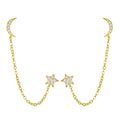 Pair of gold-tone earrings with crescent moon studs, dangling chain, and star charms set with crystals.
