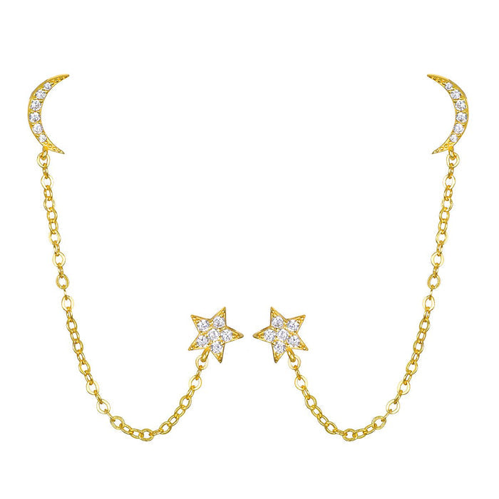 Gold chain earrings with crystal-studded crescent moons at the top and star charms suspended in the center.