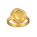 Gold ring featuring a circular dome with crescent moon and stars engraved on the face.