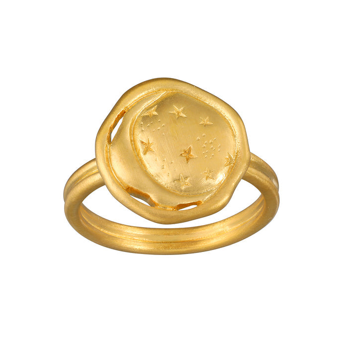 Gold ring featuring a circular dome with crescent moon and stars engraved on the face.