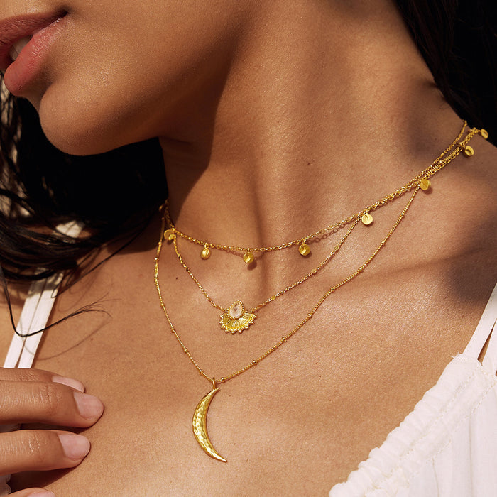 Close-up of the Moon Phases of Femininity Gold Choker layered with additional gold necklaces, highlighting its intricate details. This choker reflects the beauty of sacred feminine energy, serving as a powerful amulet for meditation, yoga, and meaningful daily wear.