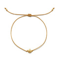 Gold-toned lotus charm pendant on tan cord bracelet with adjustable sliding knot closure.