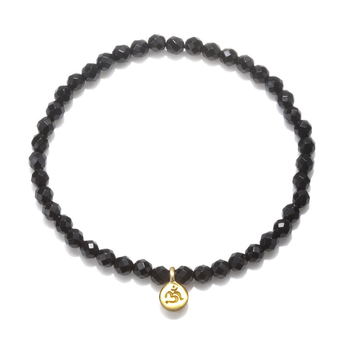 Om Black Onyx Gemstone Bracelet featuring faceted black onyx stones and a gold Om pendant, perfect for spiritual jewelry, meditation gifts, and yoga practices. This meaningful piece is a protective amulet embodying sacred and symbolic significance.