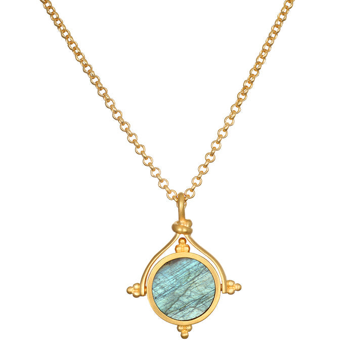 Gold-tone necklace with round labradorite pendant featuring blue-green stone in ornamental circular frame with four small sph