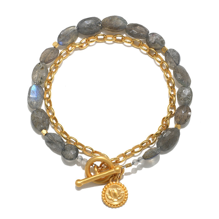 Gray labradorite beads with gold-tone chain and toggle clasp, featuring a gold lotus pendant charm.
