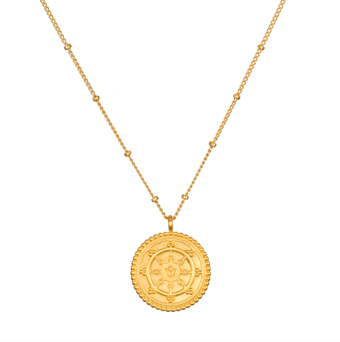 Pathway to Love Necklace in gold featuring a delicate lotus flower and Tibetan Wheel of Life pendant. This spiritual jewelry promotes meditation, embodying a talisman for zodiac signs and enhancing spiritual practices like yoga, offering protection and manifestation purpose.