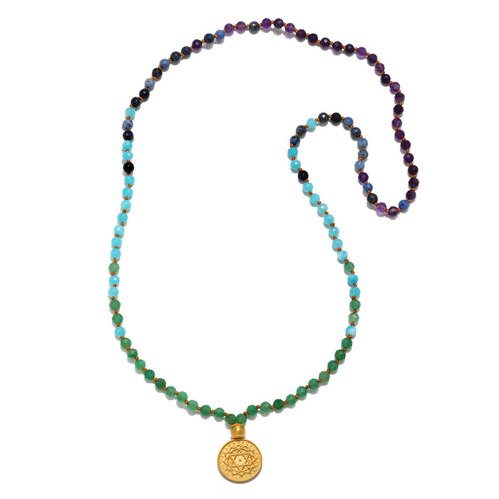 Beaded mala necklace with green, turquoise, blue, and purple stones, gold pendant charm at bottom.