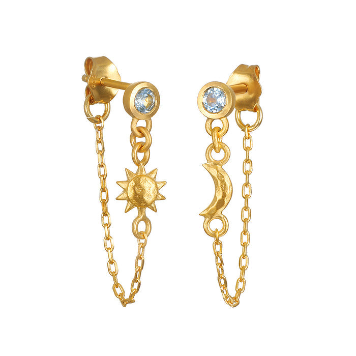 Promise of Magic Earrings featuring blue topaz, sun, and moon pendants, embodying spiritual jewelry and meaningful talismans for meditation and manifestation. Perfect for yoga enthusiasts, this design combines elements of protection and zodiac symbolism.