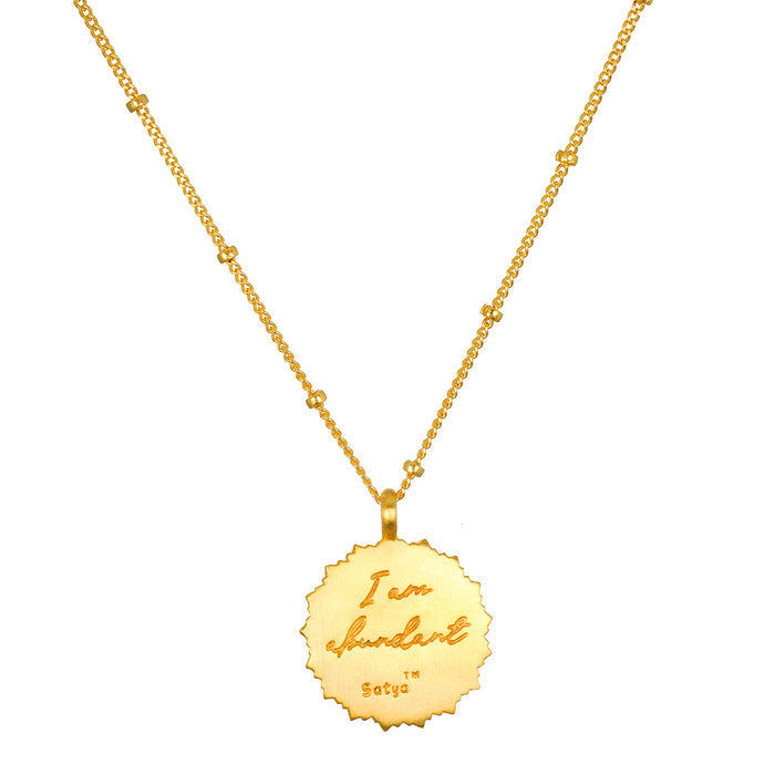 The back of the Prosperous Blessings Lakshmi Necklace features the inscription 'I Am Abundant,' reinforcing its role as a talisman. This spiritual jewelry encourages manifestation while practicing meditation and connecting with deeper meanings in spirituality.