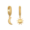 Gold-plated huggie hoops with textured bands and mismatched charms—one crescent moon and one star pendant.