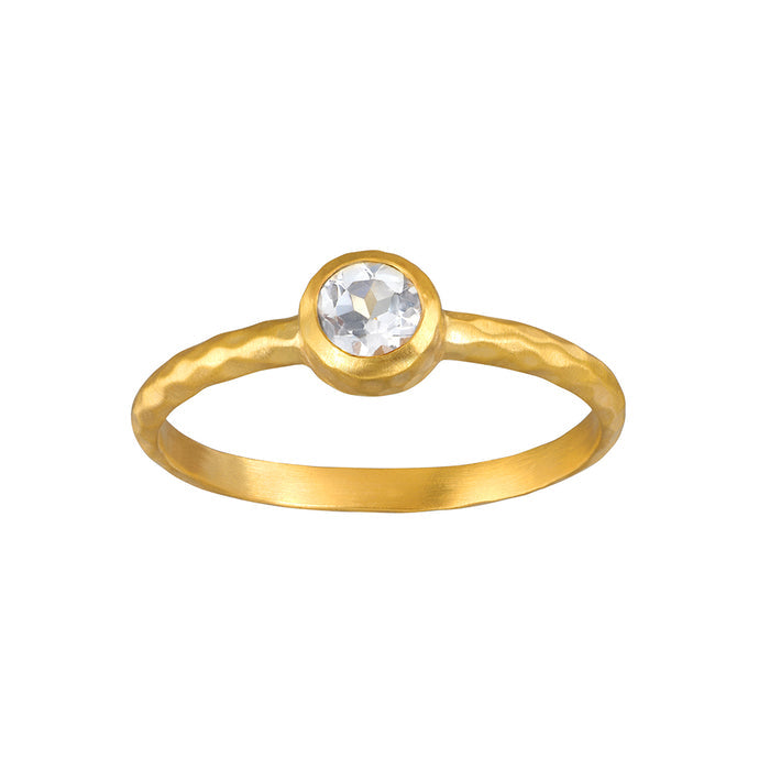 Gold ring with round clear crystal stone set in bezel setting on brushed band.