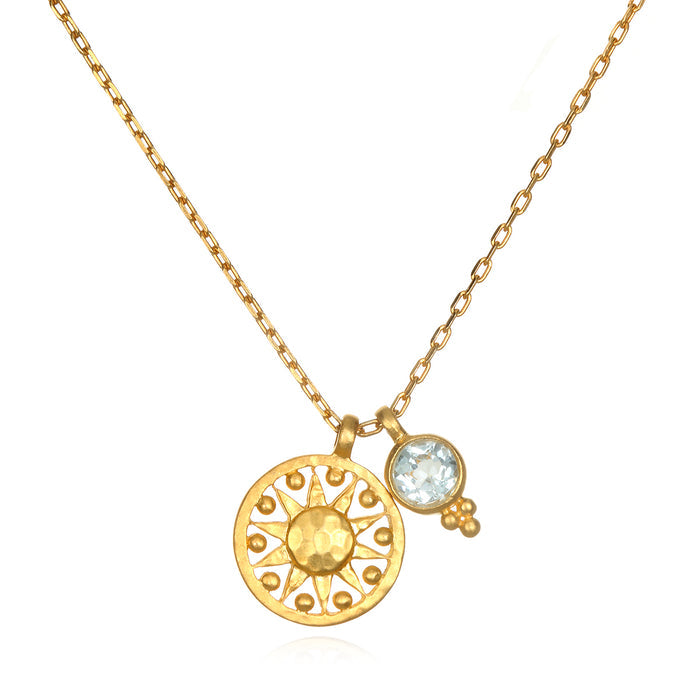 Radiate Love Sun Necklace featuring an 18k gold plated sun charm and blue topaz, perfect for those who appreciate spiritual jewelry and seek meaningful connections in yoga and meditation.