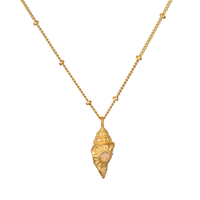 Gold-toned conch shell pendant with opal stone center on segmented gold chain necklace.