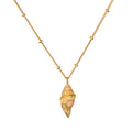 Gold-toned conch shell pendant with opal stone center on segmented gold chain necklace.