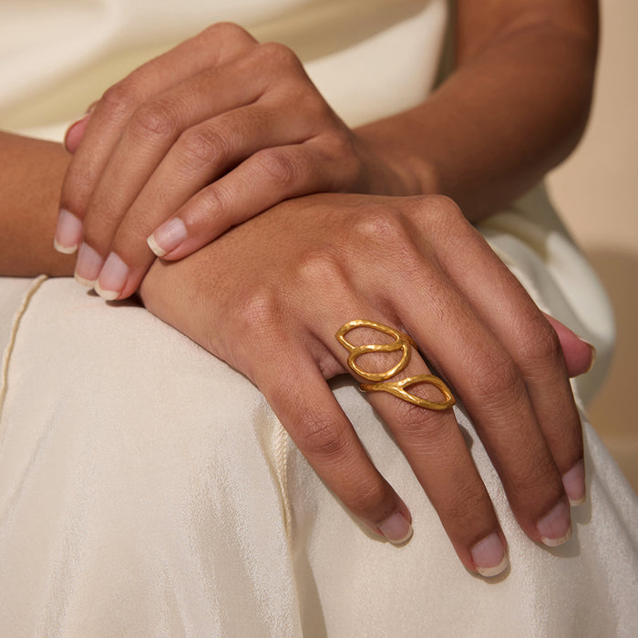 A person wearing the Rooted in Transformation Lotus Adjustable Open Ring, embodying the essence of spiritual jewelry and meaningful expression with themes of meditation, protection, and yoga.