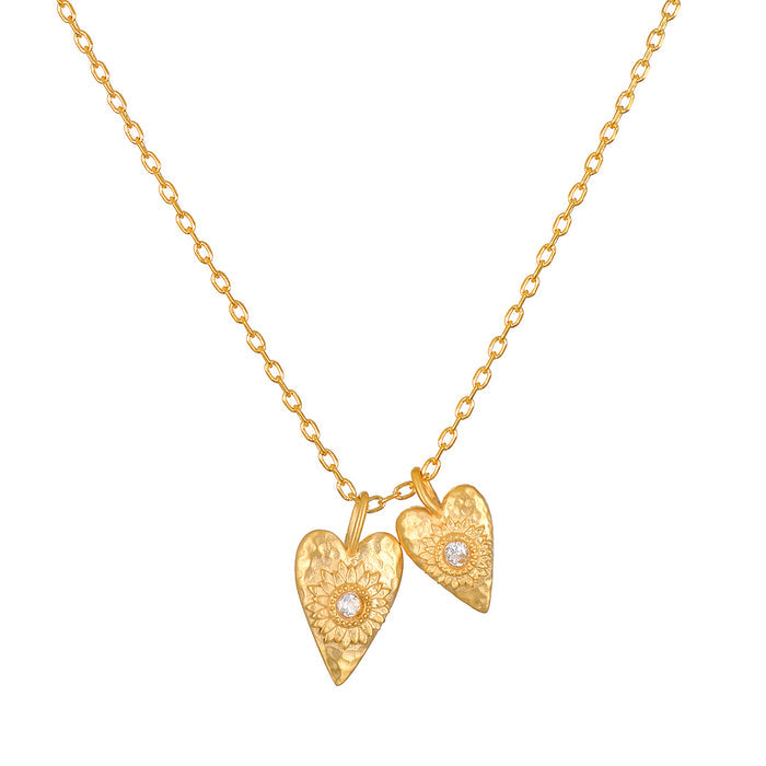 Stunning Sacred Connection White Topaz Lotus Heart Necklace featuring two heart-shaped pendants, symbolizing love, clarity, and manifestation. This spiritual jewelry piece is perfect for meditation and as a meaningful talisman for protection in yoga practice, representing both the sun and moon.