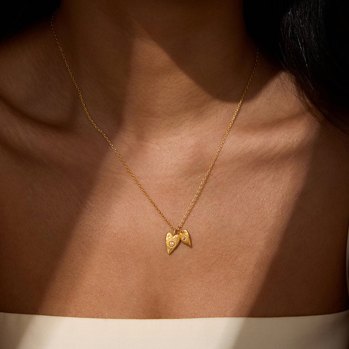 Close-up view of the Sacred Connection White Topaz Lotus Heart Necklace worn elegantly, showcasing its intricate design and the double heart motif. This spiritual jewelry enhances connection and intuition, ideal for those seeking a meaningful piece for meditation, malachite, and manifestation.