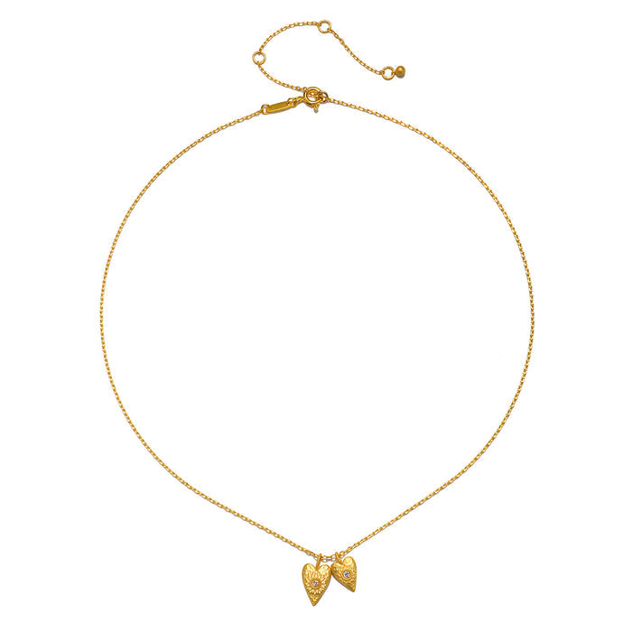 The Sacred Connection White Topaz Lotus Heart Necklace displayed with its adjustable chain, highlighting the beautiful heart pendants that symbolize love and clarity. A perfect talisman for yoga and spiritual practices, this meaningful piece represents protection and manifestation.