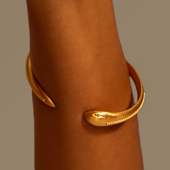 Close-up of the Sacred Guidance Snake Cuff Bracelet worn on a wrist, showcasing its sleek design. This statement piece embodies the essence of spiritual jewelry and serves as a meaningful talisman, ideal for meditation and enhancing one's connection to the zodiac.