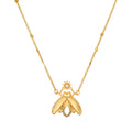 Gold-tone firefly pendant necklace with white topaz stone and beaded chain accents.