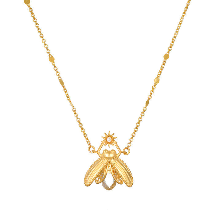 Gold-tone firefly pendant necklace with white topaz stone and beaded chain accents.