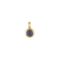 Close-up of the Sapphire Bezel Charm featuring a deep blue sapphire set in 18kt gold plate, representing trust, protection, and love. A beautiful piece of spiritual jewelry for those who seek meaning and manifestation in life, ideal for adding to charm necklaces. Perfect for yoga practitioners and meditation enthusiasts.