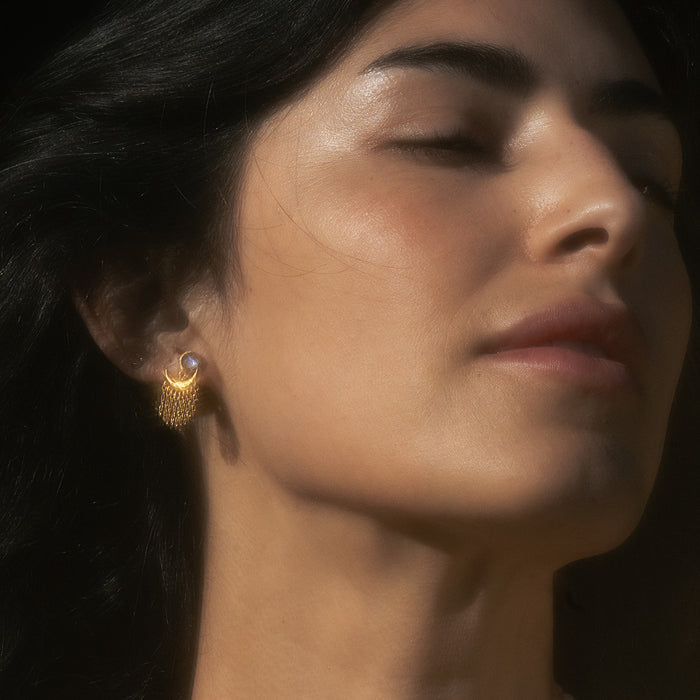 Model wearing Scattering Stardust Moonstone Fringe Stud Drop Earrings, capturing the serene beauty of moonstone as a meaningful piece of spiritual jewelry that enhances meditation and represents the balance of sun and moon energies for personal manifestation and protection.