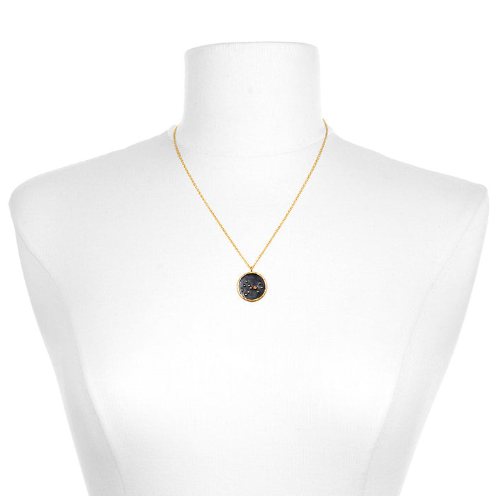 A Scorpio Zodiac Necklace displayed on a mannequin, showcasing its 18kt gold plate and gunmetal over brass design. This spiritual jewelry serves as an amulet for manifestation and protection, making it a perfect meditation gift for those interested in yoga and meaningful symbolism.