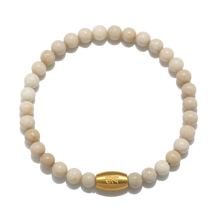 Seeking Truth Men's River Stone Bracelet featuring smooth round 6mm river stones and an engraved 18kt gold plated charm with the word 'truth' in both English and Sanskrit. This elegant piece is perfect for spiritual jewelry, meditation practices, and as a meaningful talisman for manifestation, offering protection and energy for your journey in yoga and beyond.