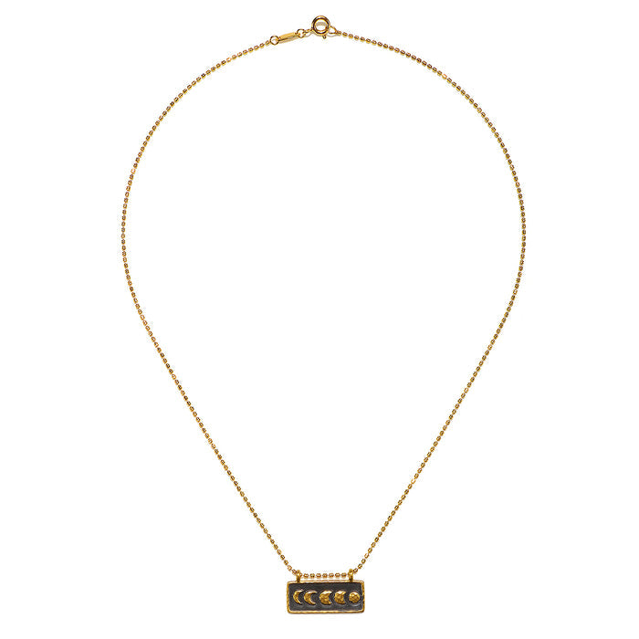 The elegant Self Evolution Moon Phase Necklace displayed against a white backdrop, highlighting its unique design and spiritual significance, ideal for those seeking protection and meaning in their jewelry.
