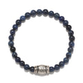 Self Knowledge Men's Dumortierite Bracelet in deep blue tones featuring a unique silver 'om' charm, ideal for spiritual jewelry and meditation practices. This talisman represents positivity, making it a meaningful addition to your zodiac or malas collection, perfect for protection during yoga and manifestation.