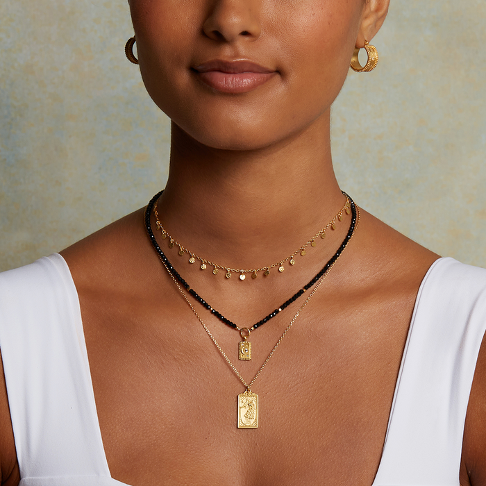 Elegant close-up of a model wearing the Shimmering Sky Choker Necklace with other gold pieces, embodying the essence of talismans for spiritual growth and meaningful connections.
