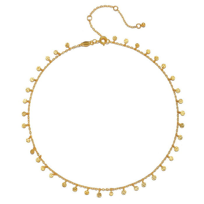 Shimmering Sky Choker Necklace featuring hammered golden discs, designed as spiritual jewelry for meditation and manifestation, with a meaningful charm for protection and connection to the sun and moon.