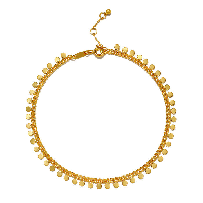 Gold-toned chain anklet with small coin charms dangling along the length and adjustable clasp.