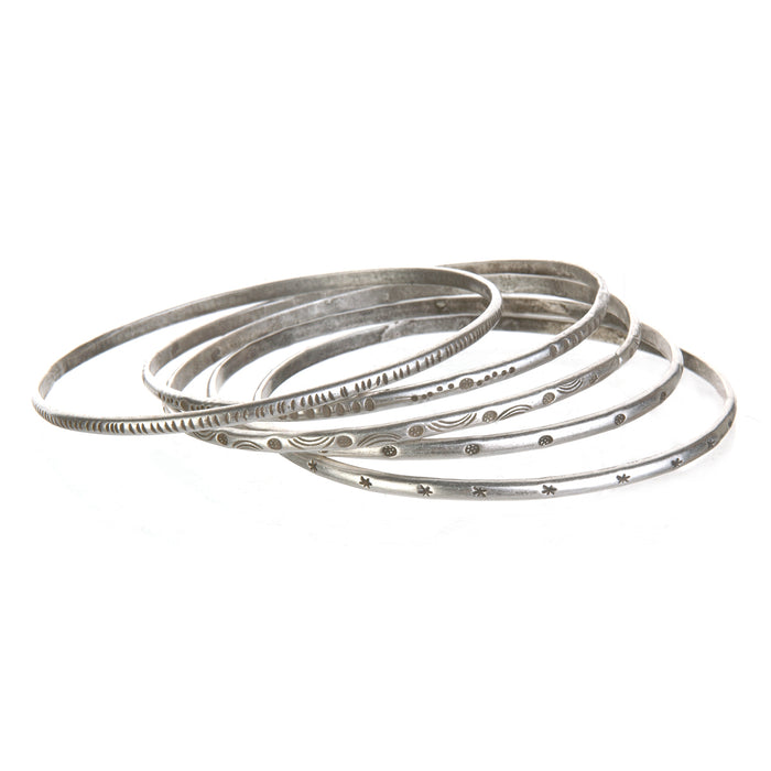 A collection of Silver Etched Bracelets Bangles titled Melody, showcasing various hand-stamped designs, perfect for spiritual jewelry and meditation gifts, embodying symbolic meaning and manifestation energy for yoga enthusiasts.