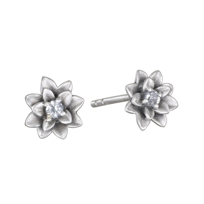 Soul Renewal Silver Lotus Earrings showcasing a beautiful lotus flower design with white topaz accents, symbolizing new beginnings and potential. These spiritual jewelry pieces serve as a perfect talisman for meditation and manifestation, connecting you to your zodiac energies while embodying protection and meaningful charm in your everyday look.